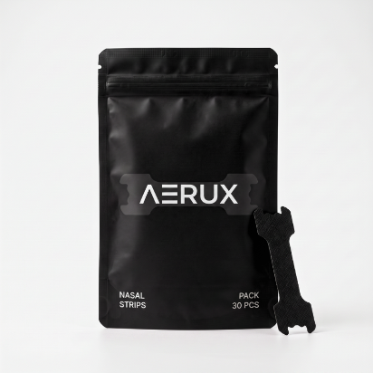 A black resealable pouch labeled AERUX Nasal Strips Pack 30 PCS, with a black nasal strip applicator leaning against the right side, photographed on a clean light gray background.
