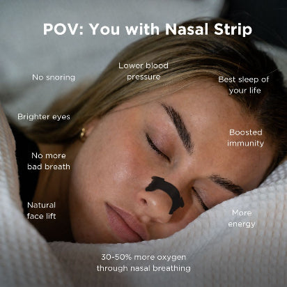 A woman sleeping peacefully with a black nasal strip applied to her nose, surrounded by white bedding.